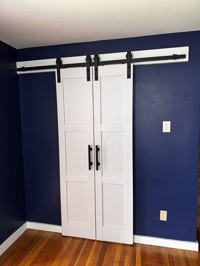 Barn door installation with blue wall paint